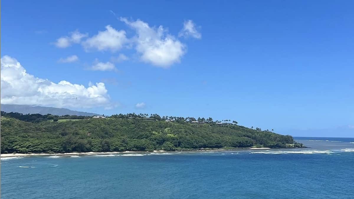 Kalihiwai Beach Kauai with the river meeting the bay and lava cliffs on the east side