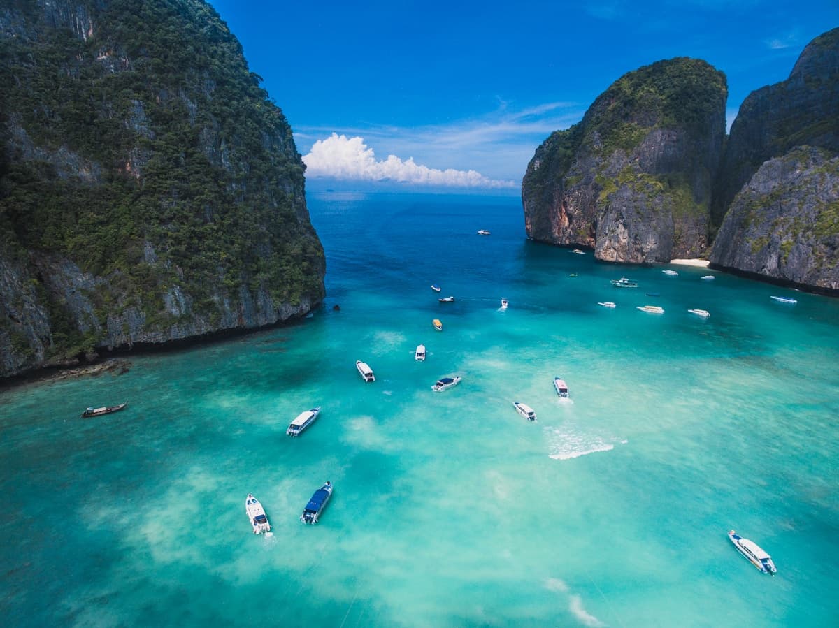 The turquoise waters and towering limestone cliffs of Maya Bay on Ko Phi Phi Leh Thailand