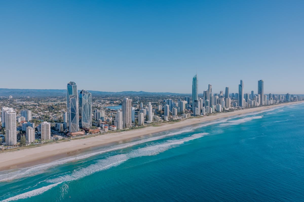 Gold Coast skyline behind a wide sandy beach with waves rolling in