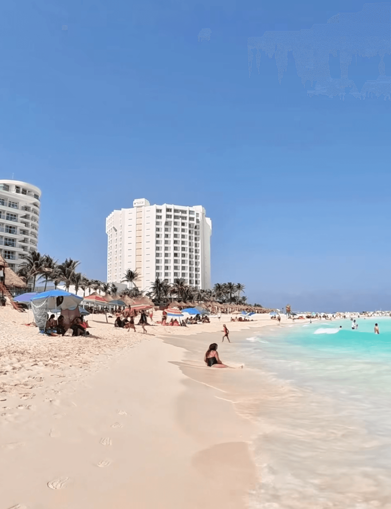 Turquoise Caribbean water and white sand at Playa Delfines Cancun
