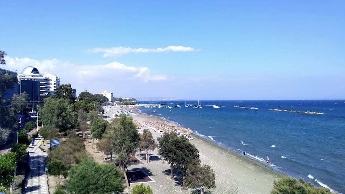 Akti Olympion B Beach Limassol Cyprus with the Blue Flag, calm water from breakwaters, and the city promenade
