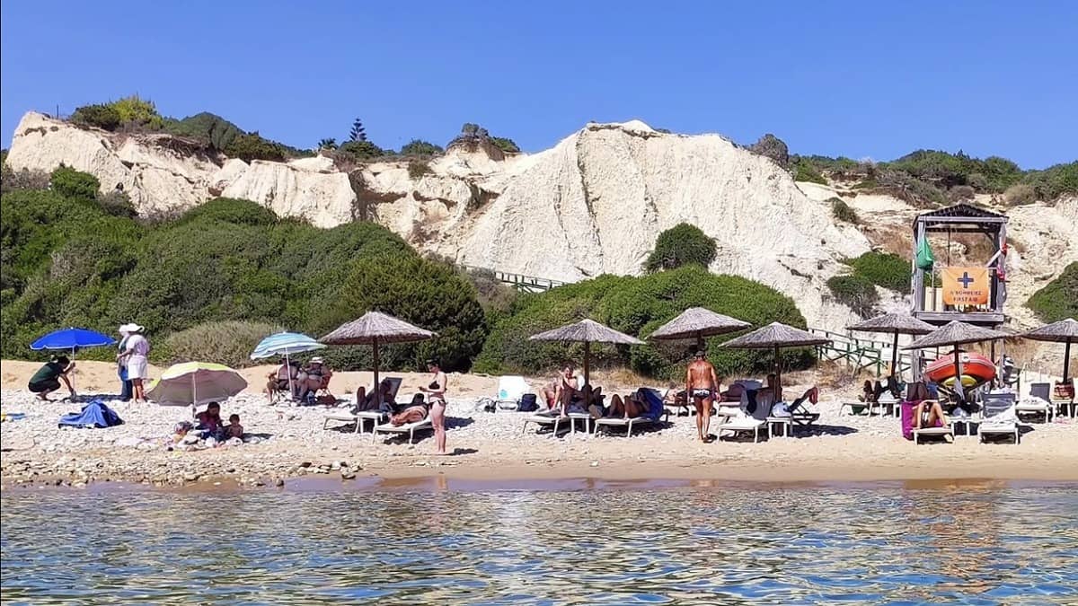 Gerakas Beach Zakynthos with the red clay cliffs behind the golden sand and the marine park protected bay