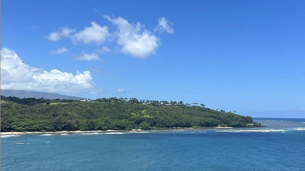 Kalihiwai Beach Kauai with the river meeting the bay and lava cliffs on the east side