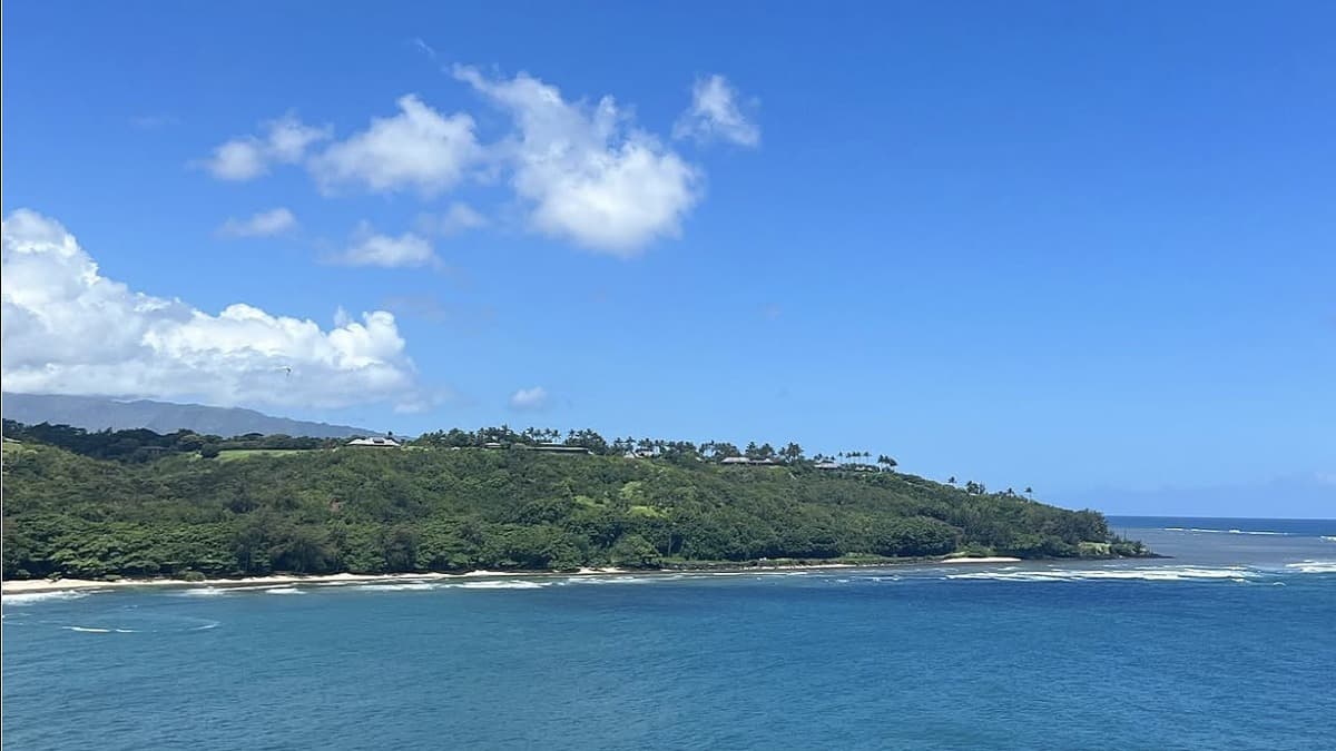 Kalihiwai Beach Kauai with the river meeting the bay and lava cliffs on the east side