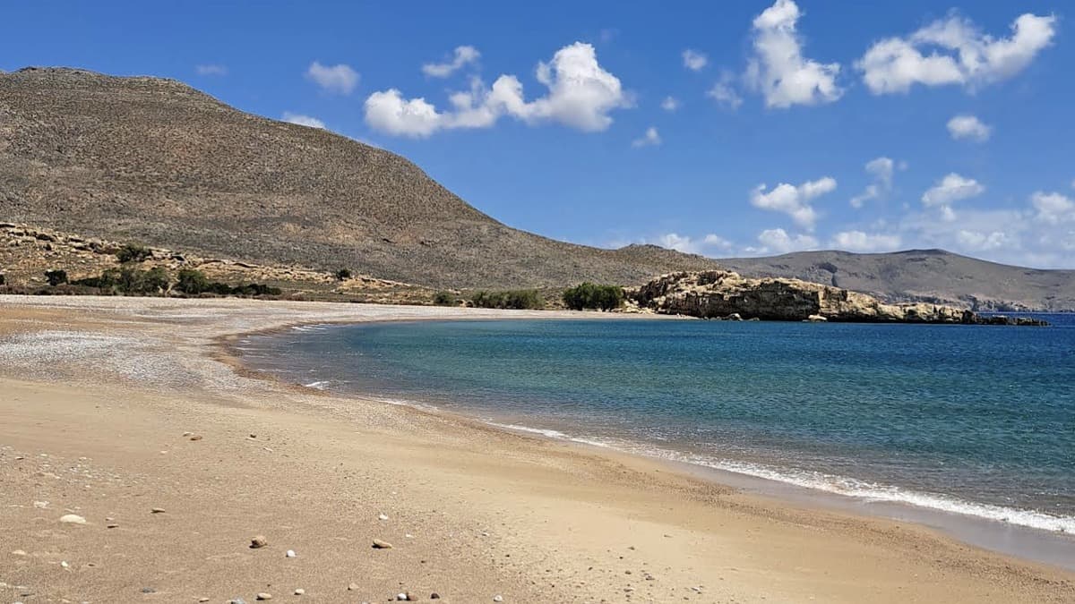 Karoumes Beach east Crete at the end of Chochlakies Gorge with calm Aegean water and pebble shore