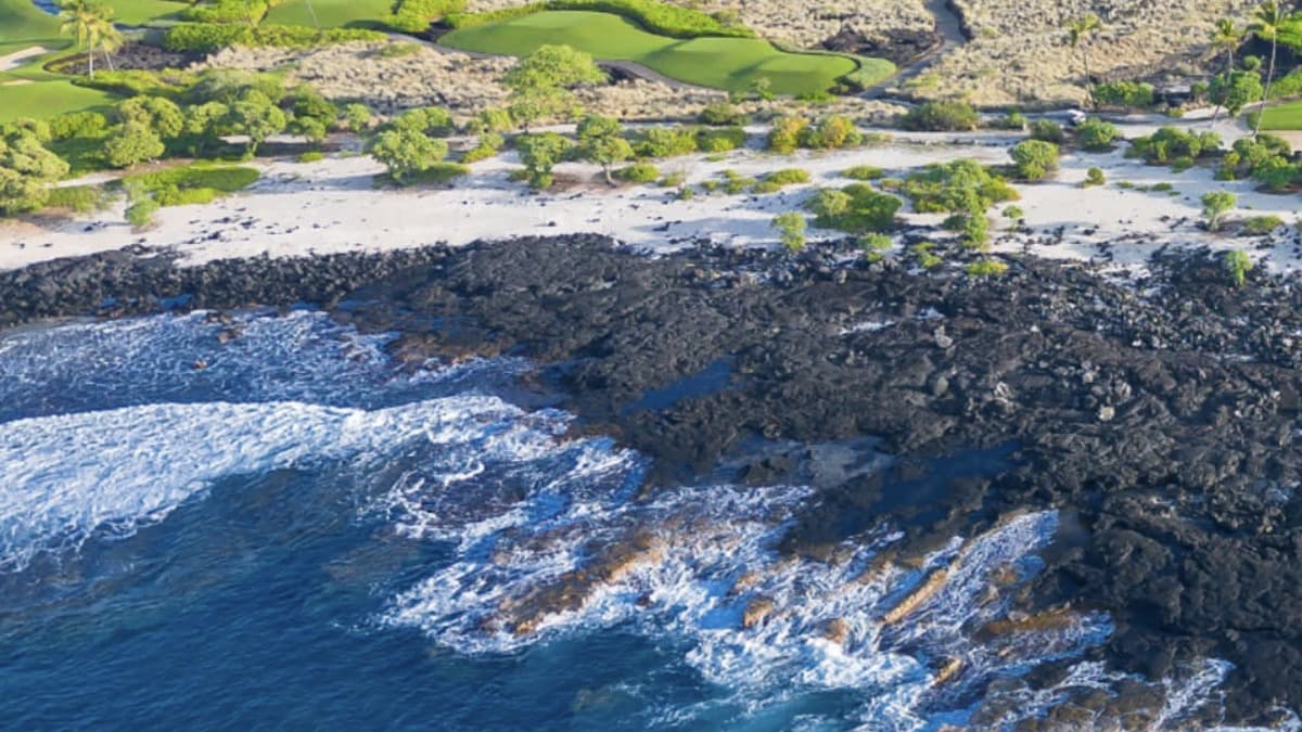 Kohanaiki Beach Park (Pine Trees) on the Big Island Kona coast with surf breaking on the lava-rock shore