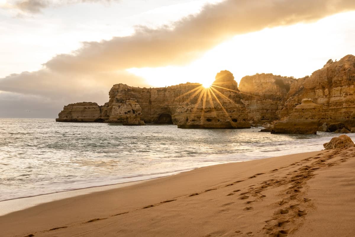 Golden limestone cliffs and turquoise water at Praia da Marinha beach in the Algarve, Portugal