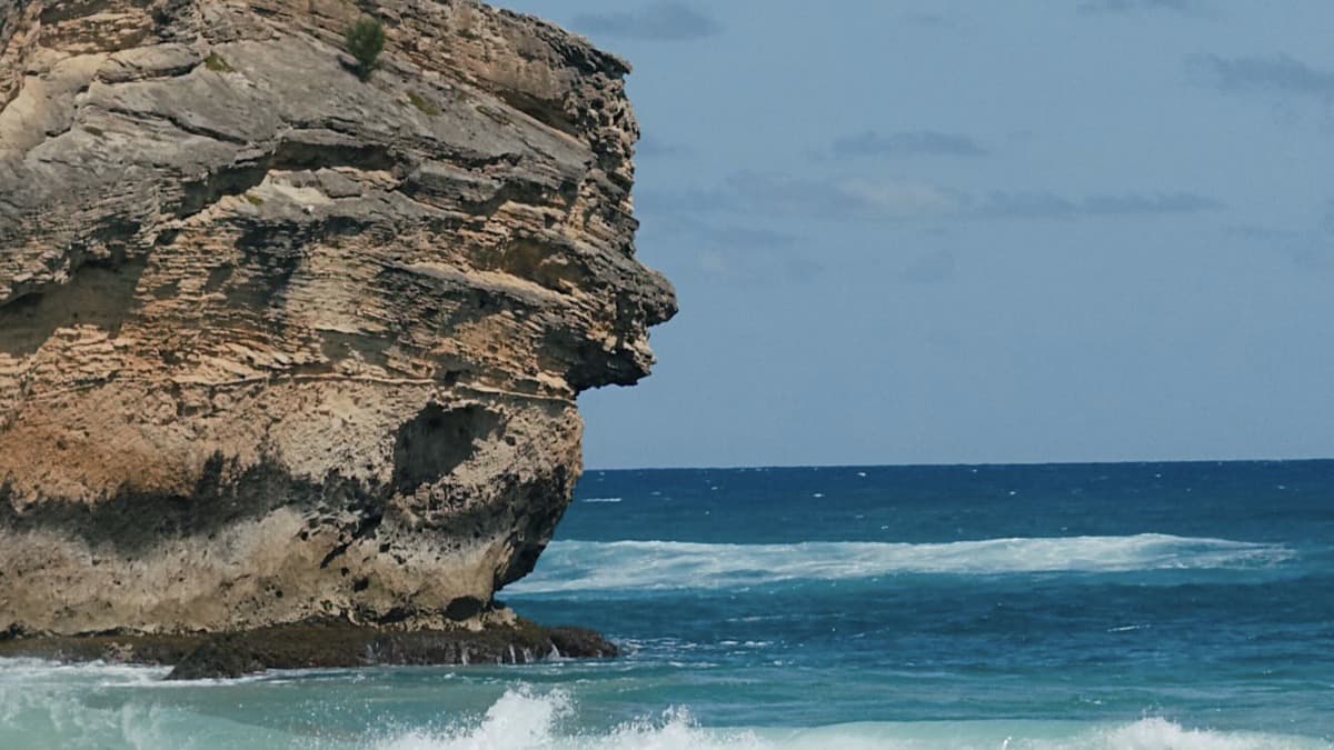 Shipwreck Beach Kauai with the Makawehi Bluff cliff at the east end and golden sand