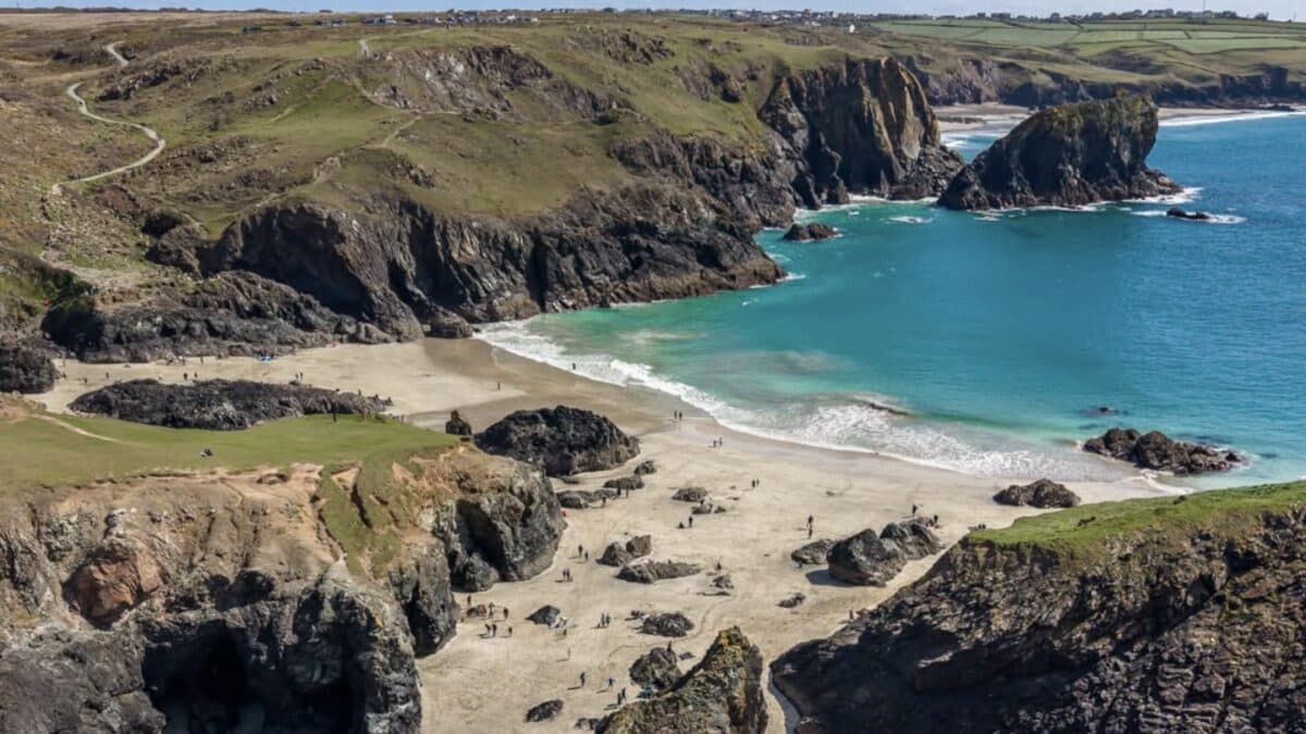 Kynance Cove on the Lizard from the cliff path, with turquoise water, white sand and the dark serpentine sea stacks