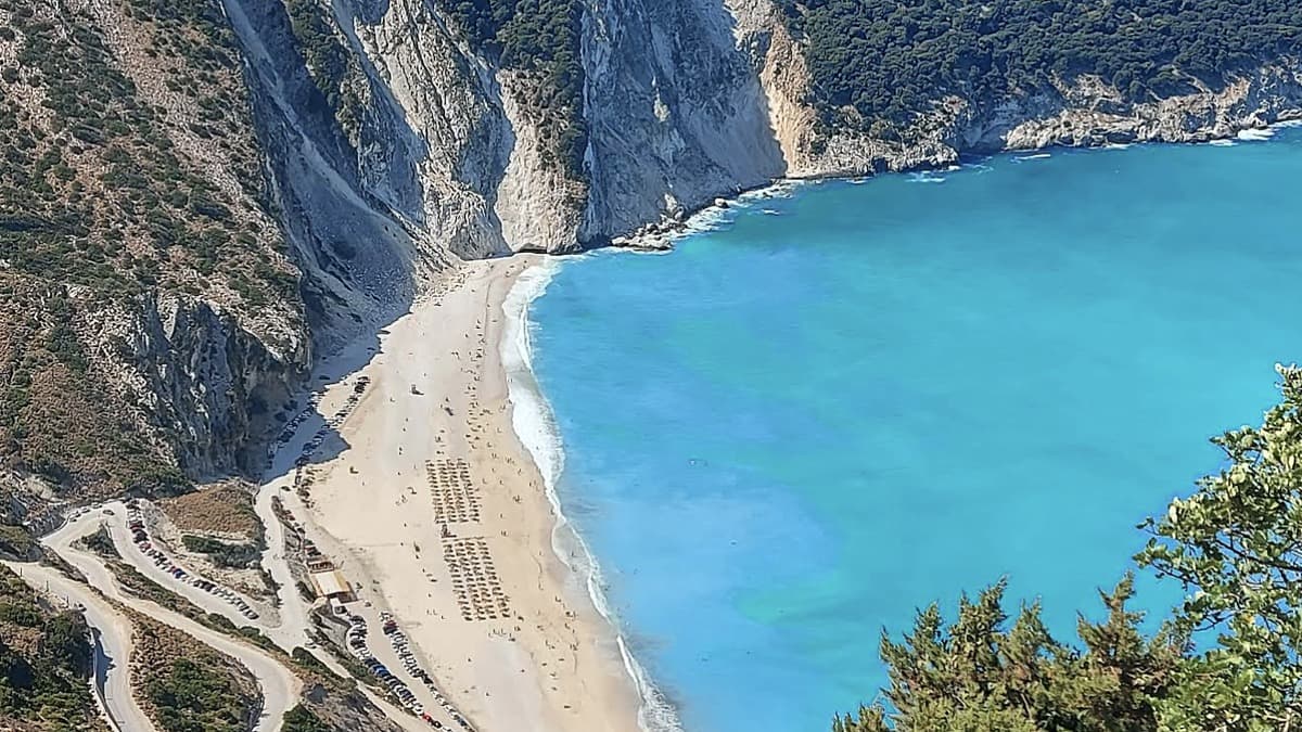 Myrtos Beach Kefalonia from the cliff viewpoint with the white-pebble crescent and turquoise Ionian water