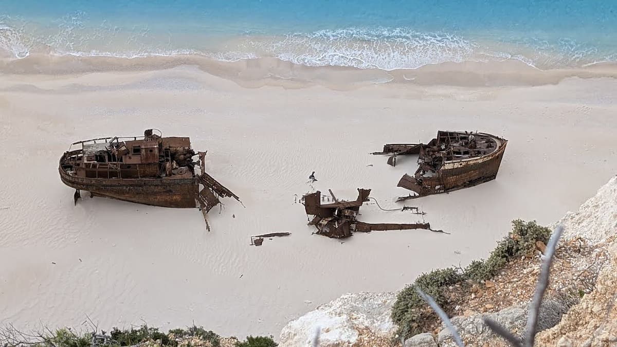 Navagio Beach (Shipwreck Beach) Zakynthos from the cliff viewpoint with the turquoise cove and rusted shipwreck on the sand