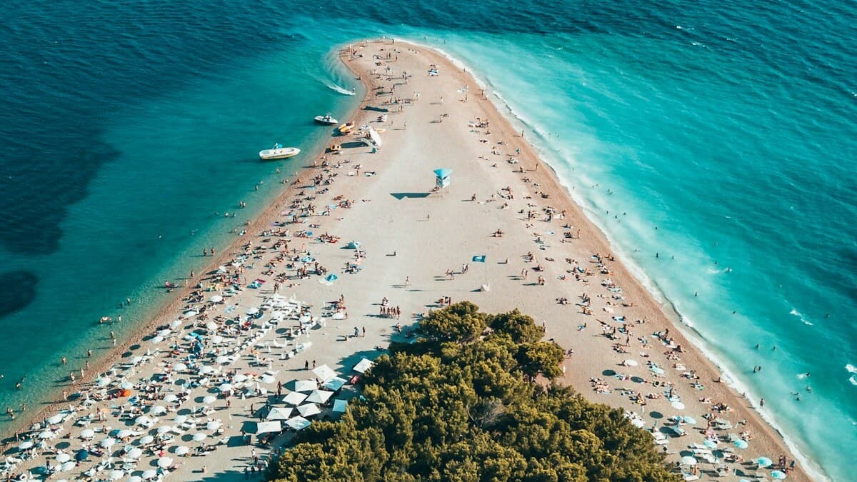 Zlatni Rat, the golden horn beach near Bol on the island of Brac, a triangular pebble spit jutting into clear turquoise water, Croatia