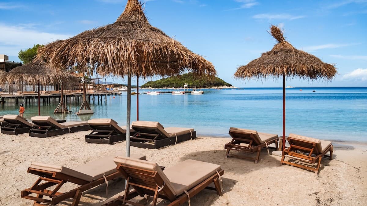 The turquoise water and small swimmable islands off Ksamil on the Albanian Riviera, with white sand and pine-covered rock