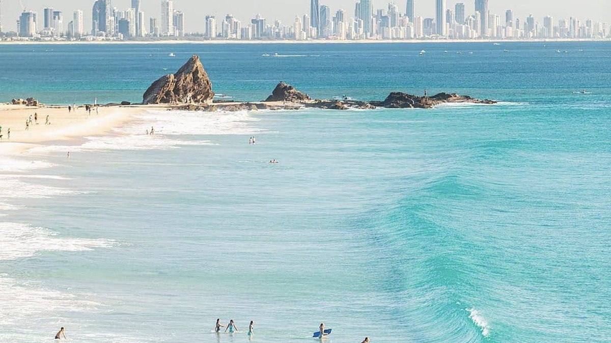 Currumbin Beach on the Gold Coast, an ocean beach beside the calm shallow Currumbin Creek