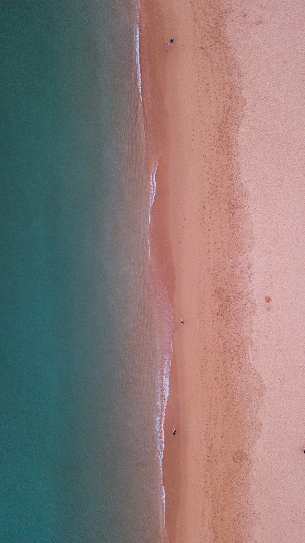 Wide golden sand beach with dramatic rock formations at Praia da Rocha Portimao
