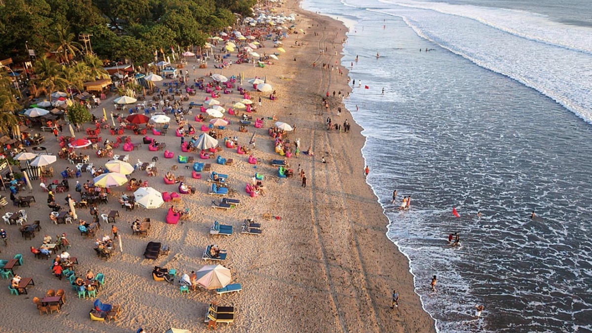 Kuta Beach in Bali, a long sandy beach with beginner surf breaks and a busy commercial strip behind