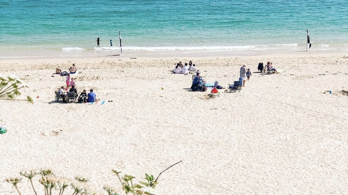 Porthminster Beach St Ives: sheltered pale sand and clear turquoise water with families on the beach