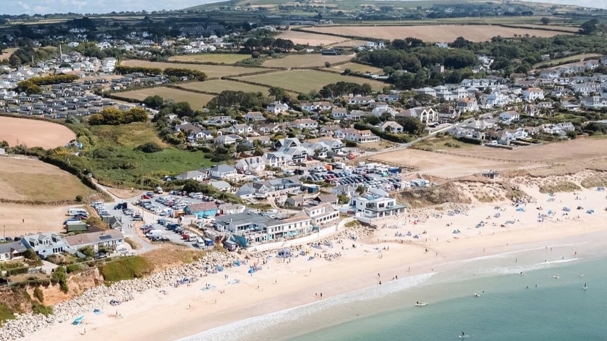 Praa Sands long stretch of golden sand backed by dunes with surf rolling in, on the south coast between Helston and Penzance