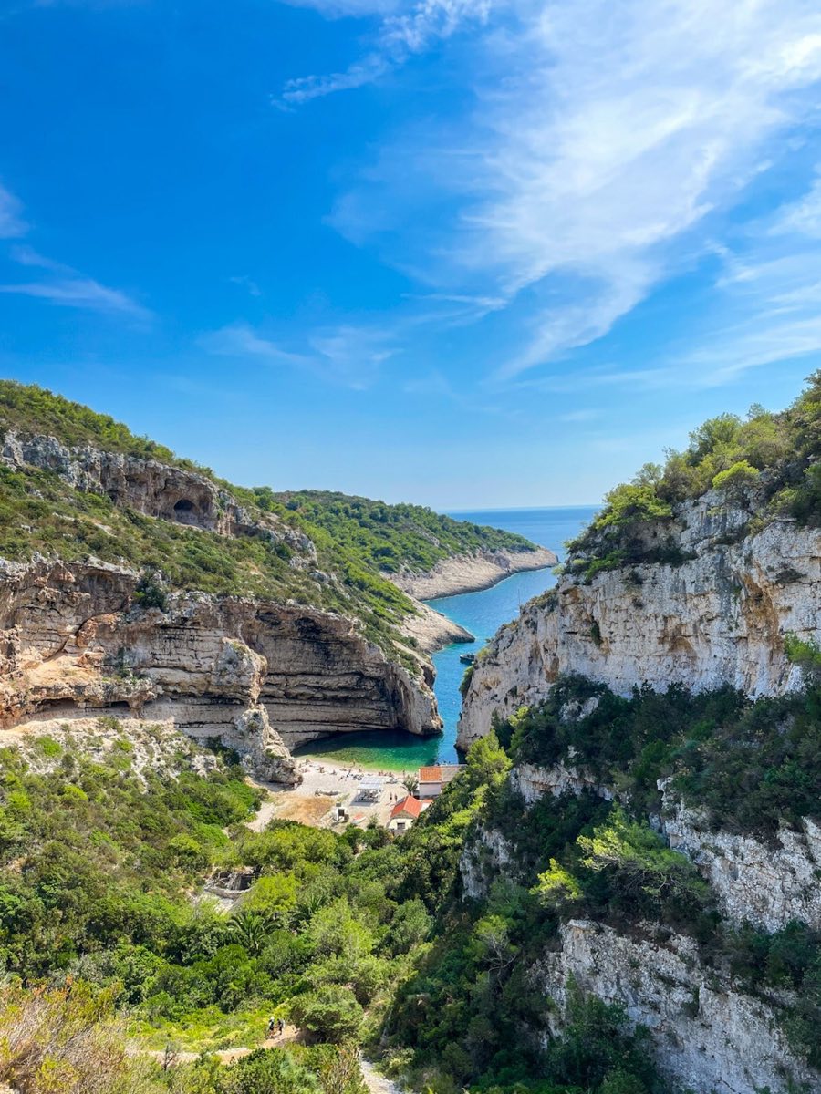 Stiniva Beach on Vis Island with dramatic cliff walls framing turquoise water