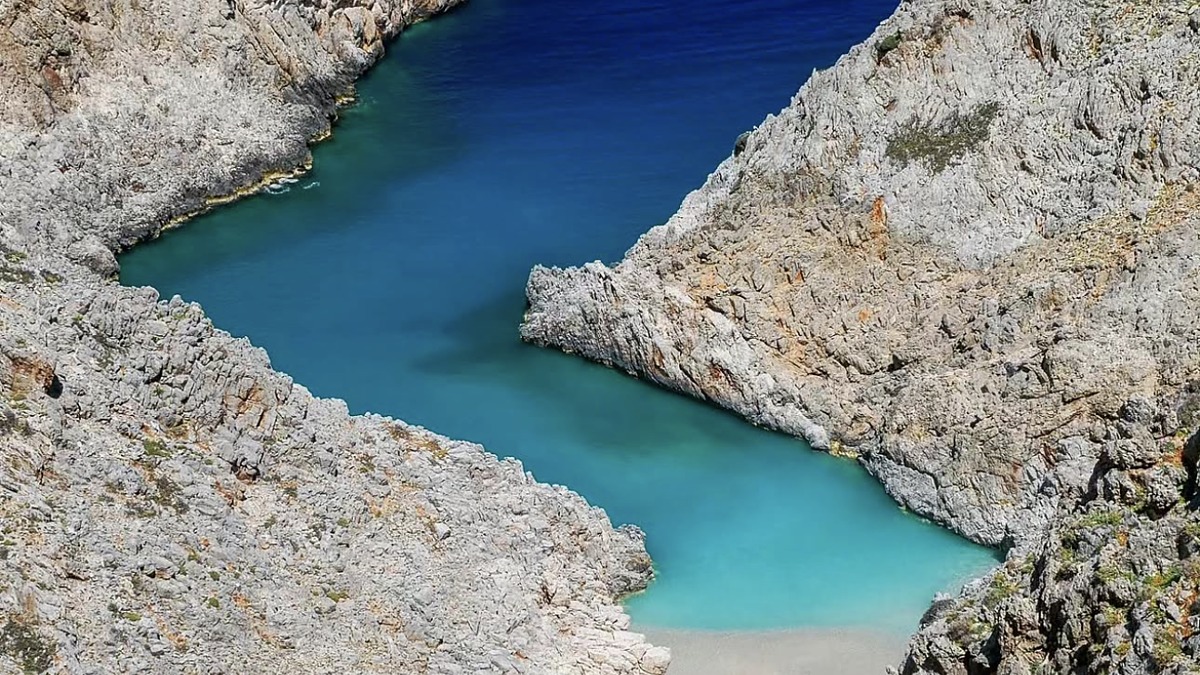 The narrow cove wedged between steep rocky walls at Seitan Limania near Chania, Crete