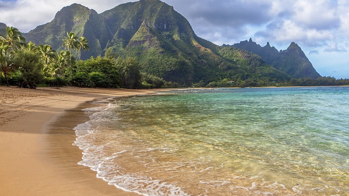 Tunnels Beach with reef visible offshore and Na Pali cliffs in the background
