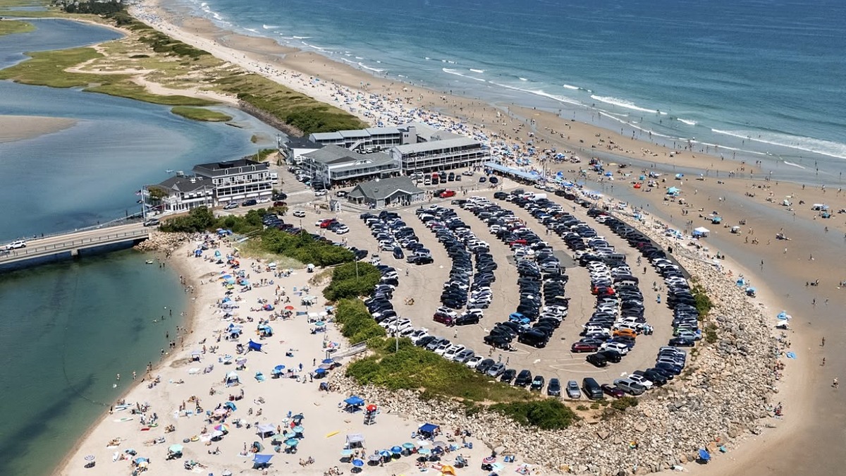 Ogunquit Beach with wide pale sand and dunes, the footbridge over the Ogunquit River visible