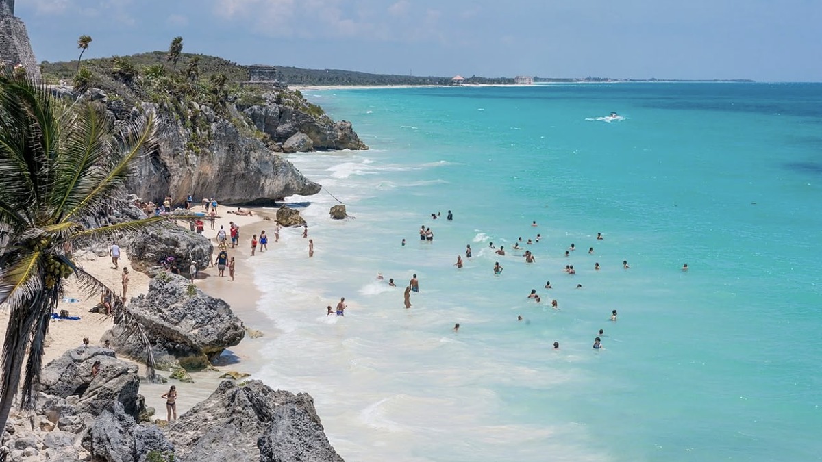 Tulum Beach with the Mayan ruins on the cliff and turquoise Caribbean water