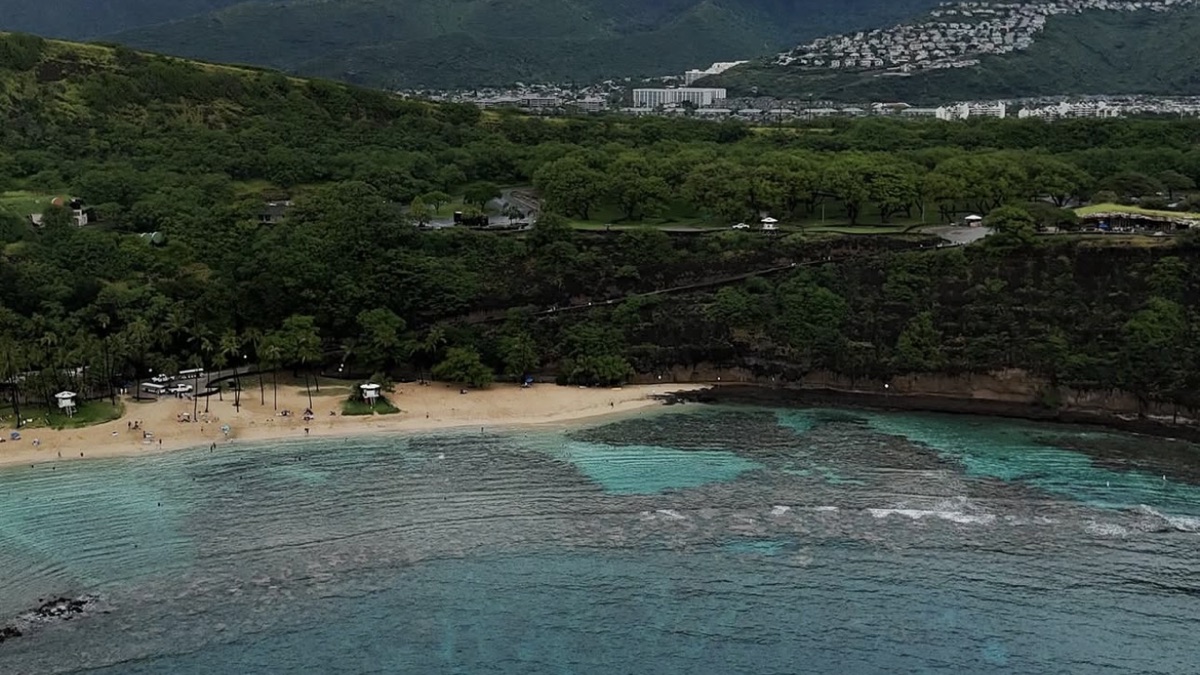 Aerial view of Hanauma Bay's curved reef and turquoise water inside the volcanic crater