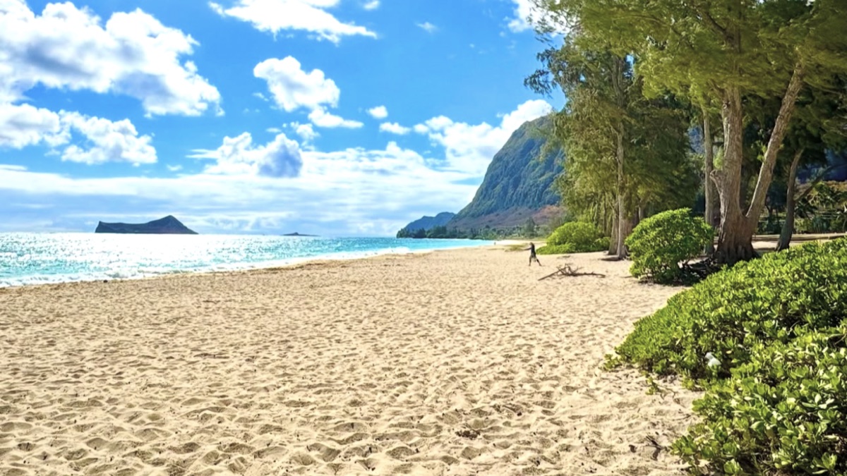 Empty stretch of Waimanalo Beach with the Ko'olau mountains in the background