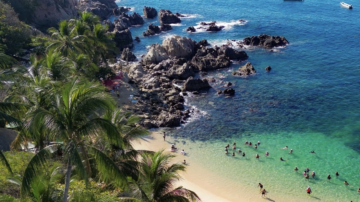 Playa Manzanillo cove in Puerto Escondido with calm water and palapa restaurants