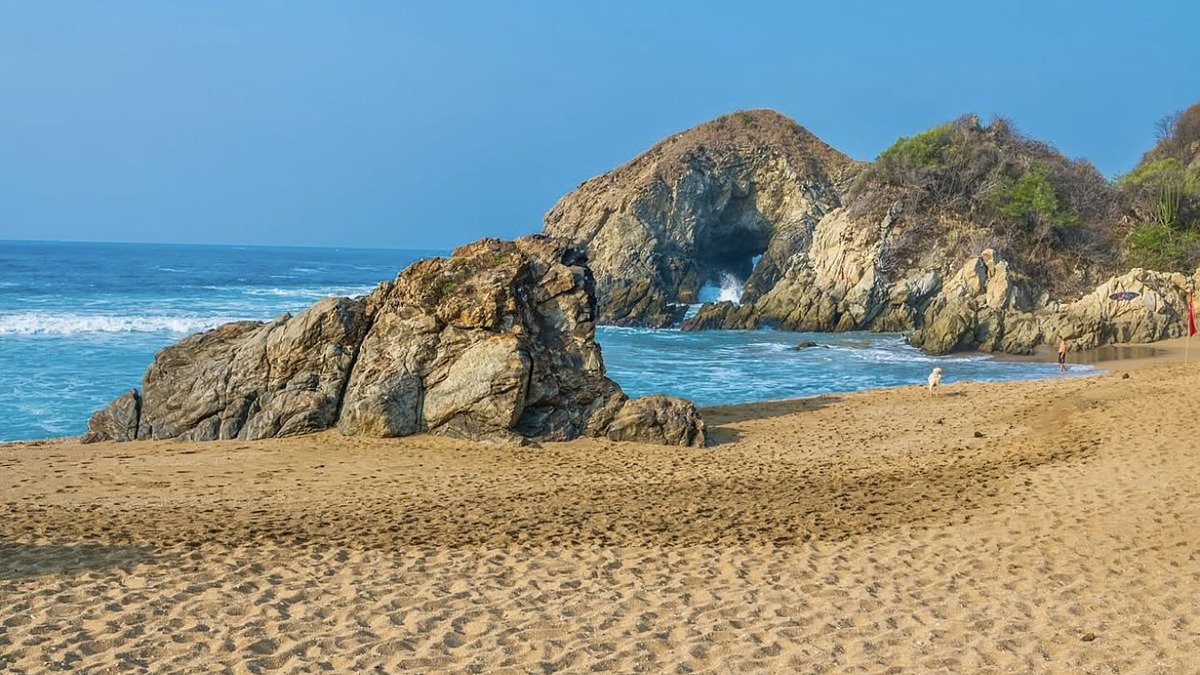 Zipolite's mile-long Pacific beach at sunset with palapa bars
