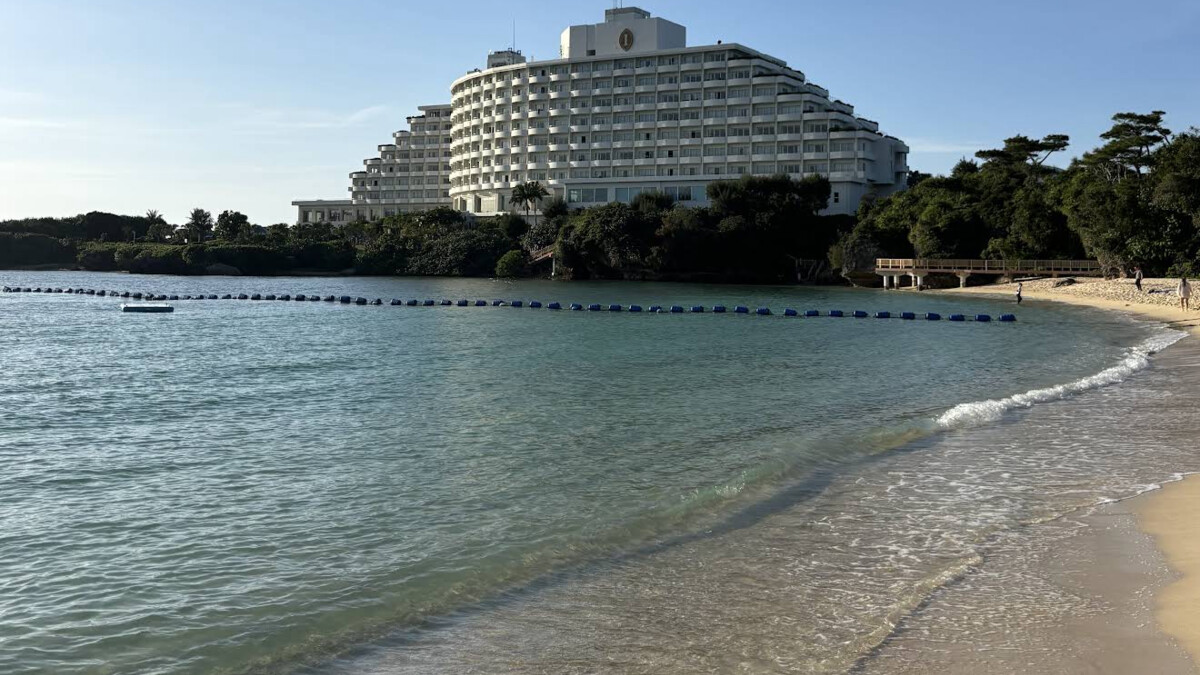 Manza Beach in Onna, a reef-protected crescent of white sand and calm water in front of the ANA InterContinental Manza Beach Resort