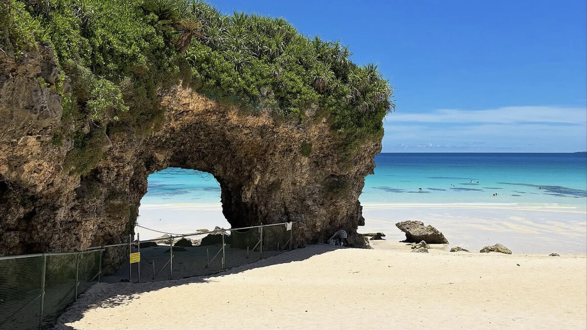 Sunayama Beach on Miyako, the natural limestone arch on white sand with clear turquoise shallows