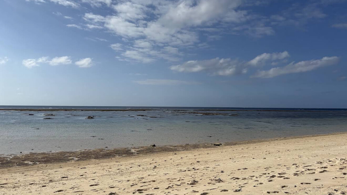 Yonehara Beach on Ishigaki, a reef-fringed snorkelling beach with the offshore reef drop-off line visible in clear water