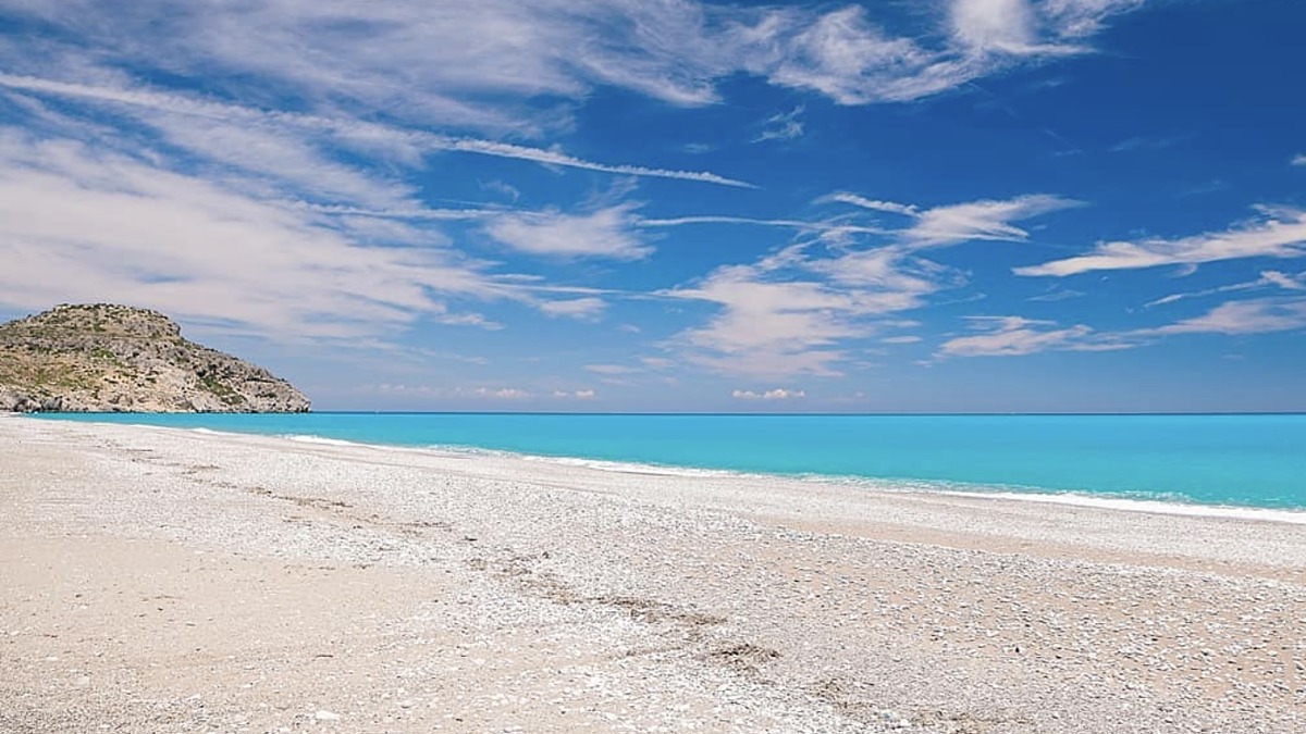 Afandou Beach south of Faliraki, a long stretch of golden sand and pebbles with quiet unorganised sections