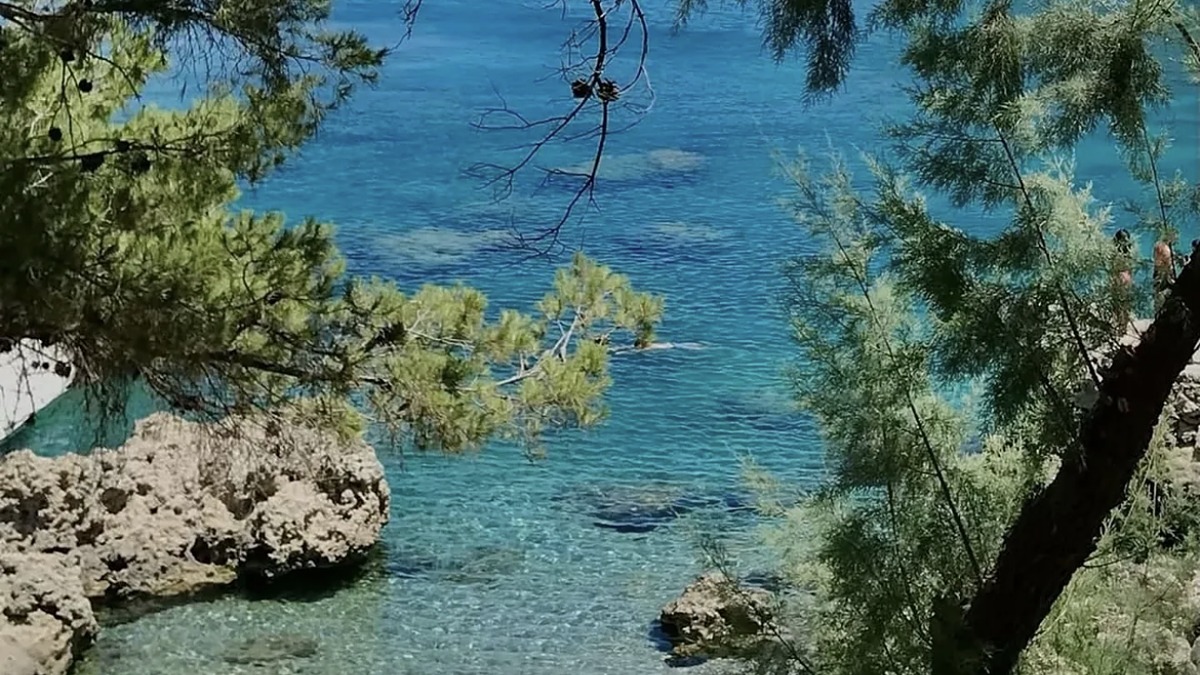 Anthony Quinn Bay (Ladiko) near Faliraki, a small rocky snorkel cove with limestone cliffs and deep clear water