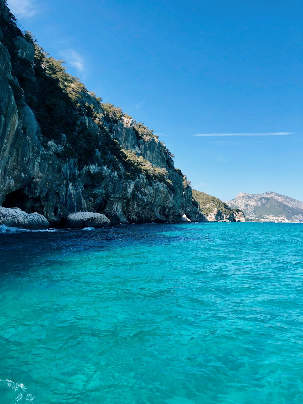 Turquoise water and dramatic cliffs at Cala Mariolu beach in Sardinia