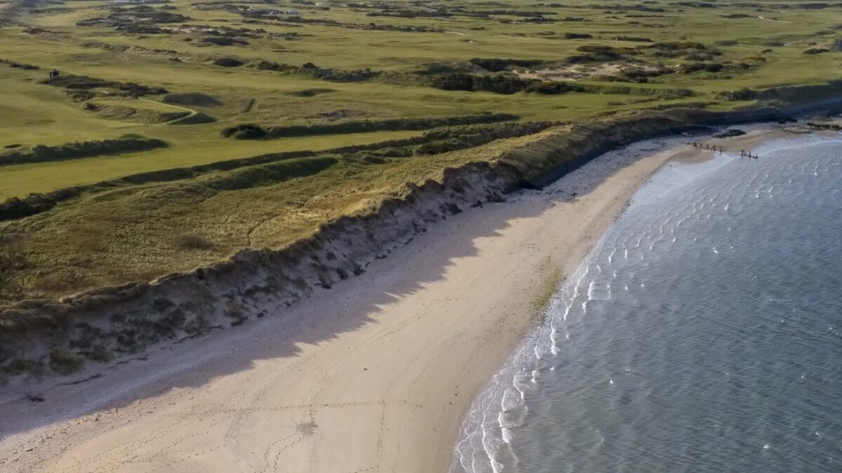 West Sands at St Andrews, the long flat golden beach backed by dunes and the Old Course golf links