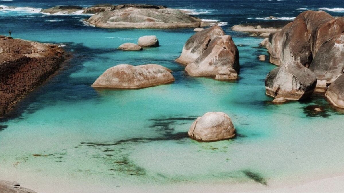 Calm turquoise lagoon at Greens Pool near Denmark ringed by large rounded granite boulders