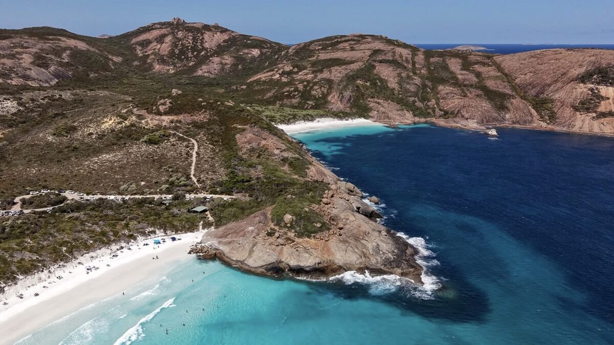 Hellfire Bay's small white-sand cove framed by tall granite headlands with very clear water, Cape Le Grand