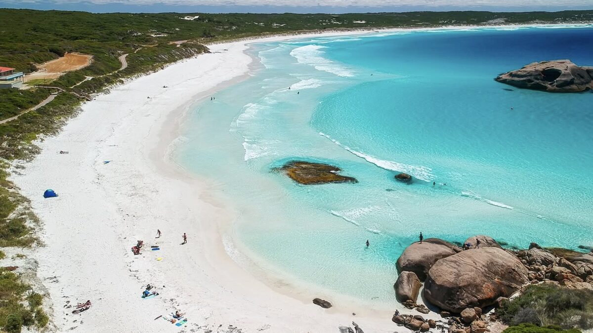 Aerial of Twilight Beach near Esperance, the curving white-sand bay with granite rock formations standing in clear turquoise water