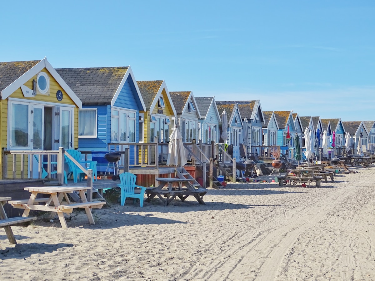Colourful beach huts on Bournemouth beach with blue sky