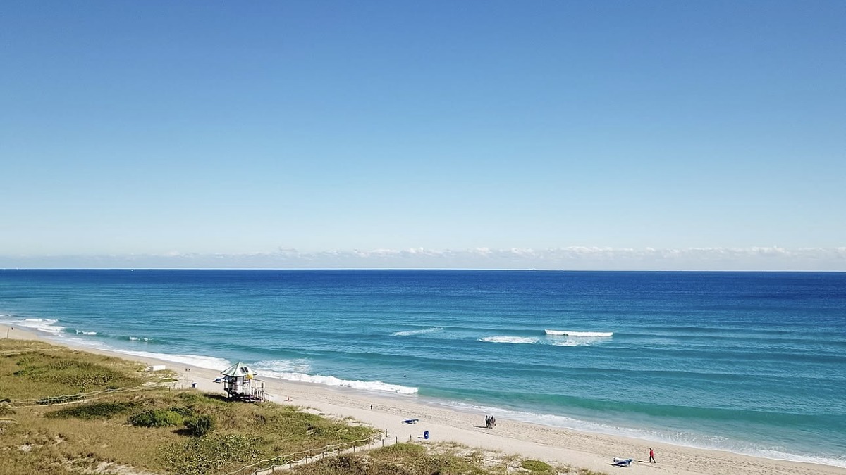 A wide well-kept beach with a lifeguard tower and dunes on Florida's Atlantic coast at Delray Beach