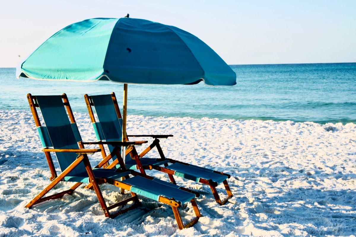 Beach chairs and umbrella on sugar-white sand in Destin Florida