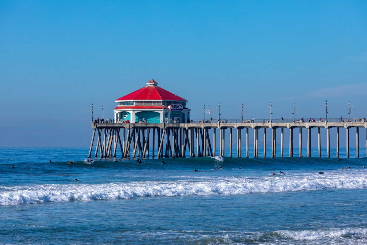 Huntington Beach Pier with Ruby's Diner and surfers in the waves