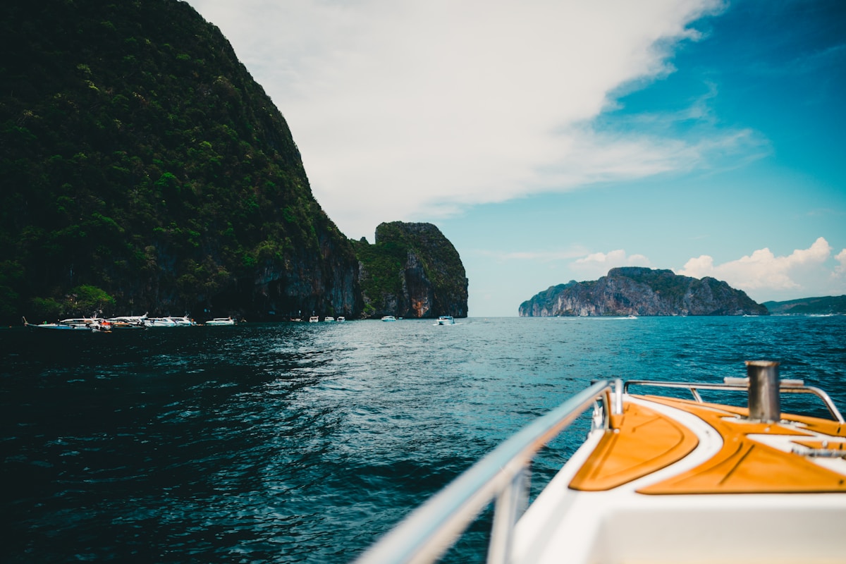 Clear turquoise water and white sand beach on Koh Lipe with longtail boats