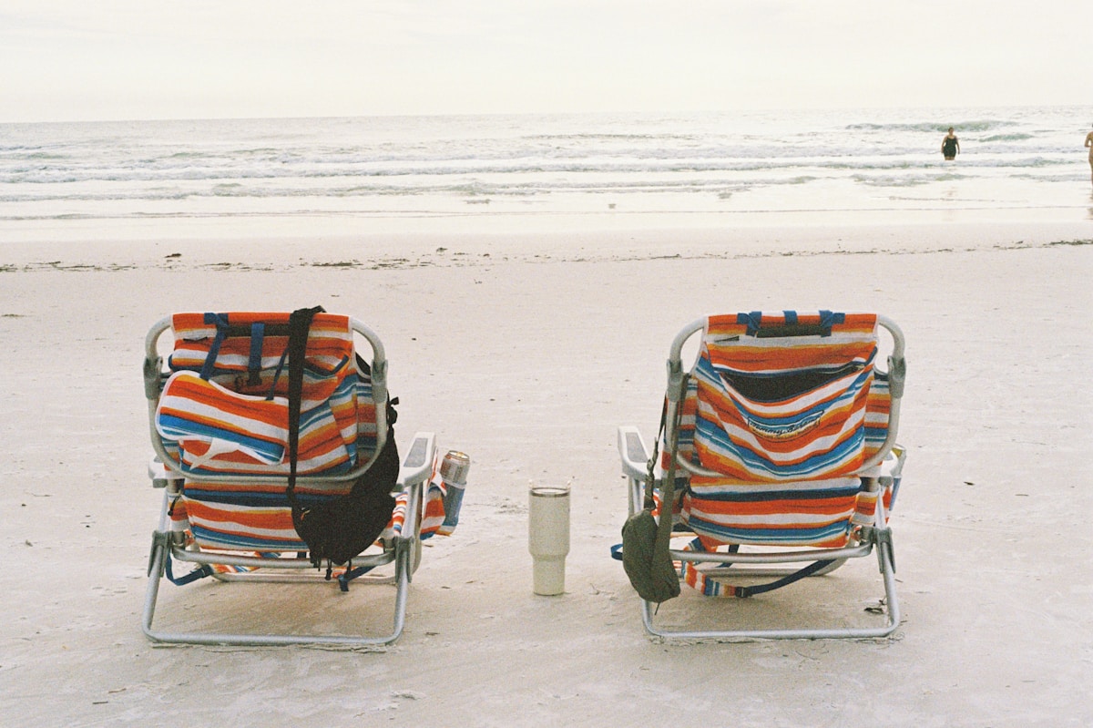 Beach chairs on Siesta Key white quartz sand with gentle waves