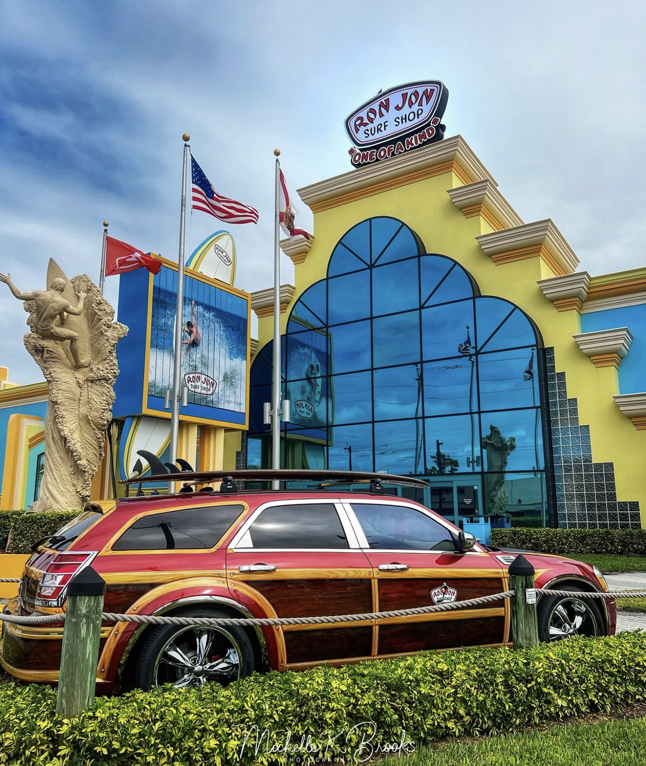 Ron Jon Surf Shop exterior with the giant surfboard signage at dusk