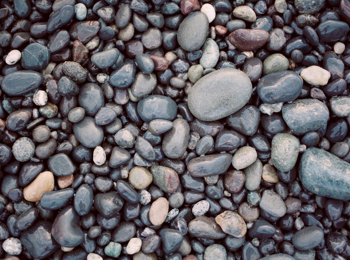 Smooth wet pebbles on a UK beach shoreline where sea glass can often be found