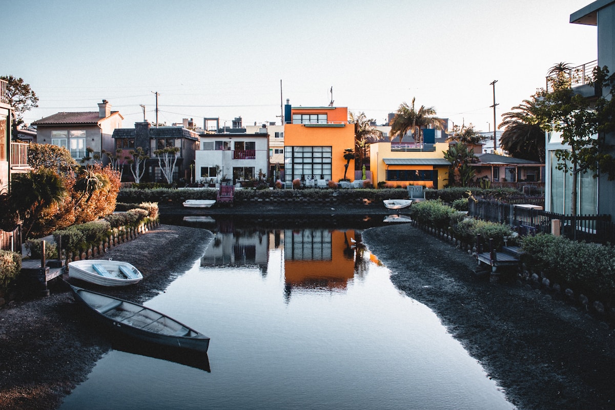 Colorful houses reflected in the Venice Canals with small boats